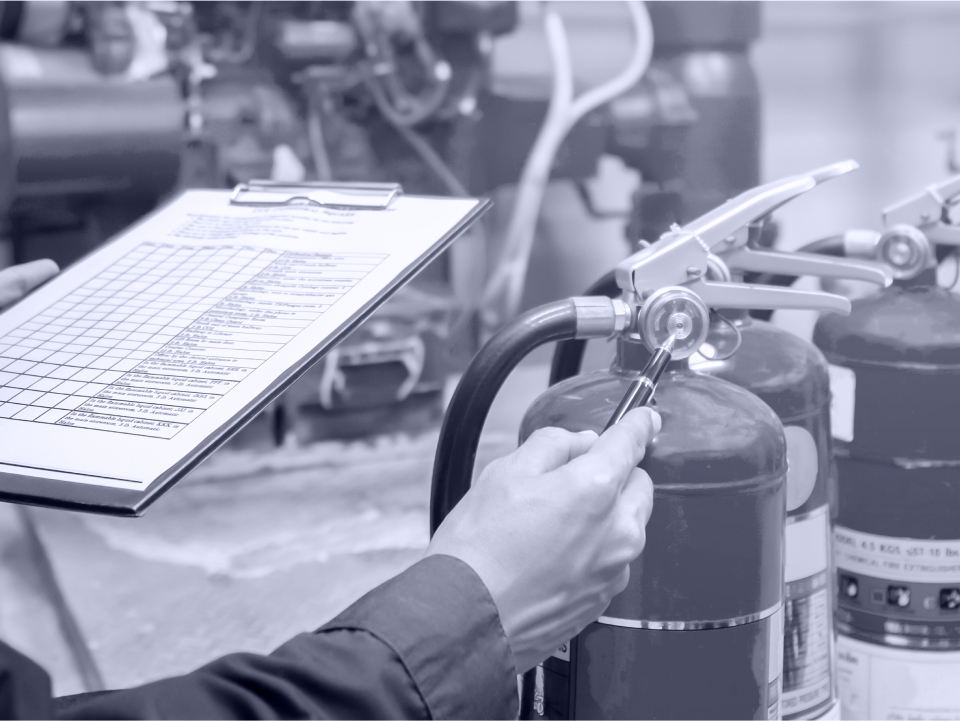 Person inspecting fire extinguisher